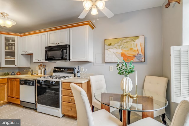 715 S Washington St Unit A-13, Alexandria, VA 22314 - kitchen with black microwave, gas range, dishwasher, a ceiling fan, and light countertops