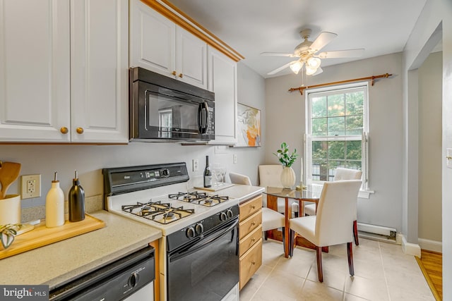 715 S Washington St Unit A-13, Alexandria, VA 22314 - kitchen with black microwave, white gas stove, dishwashing machine, ceiling fan, and white cabinetry