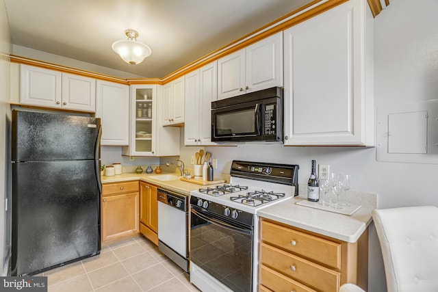 715 S Washington St Unit A-13, Alexandria, VA 22314 - kitchen with black appliances, a sink, light countertops, and light tile patterned flooring