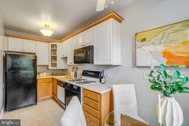 715 S Washington St Unit A-13, Alexandria, VA 22314 - kitchen featuring black appliances, light countertops, light tile patterned flooring, a sink, and glass insert cabinets