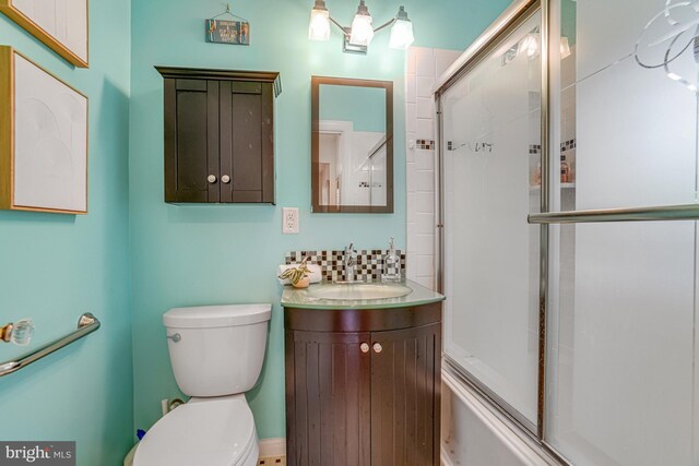 715 S Washington St Unit A-13, Alexandria, VA 22314 - full bathroom with vanity, toilet, shower / bath combination with glass door, and tasteful backsplash