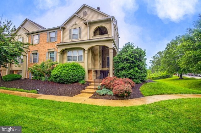 8060 Stonewall Brigade Ct Unit 101, Manassas, VA 20109 - view of front of home with a front yard and brick siding