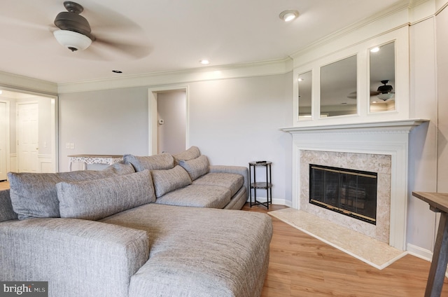 8060 Stonewall Brigade Ct Unit 101, Manassas, VA 20109 - living room featuring crown molding, light wood finished floors, a ceiling fan, a premium fireplace, and baseboards