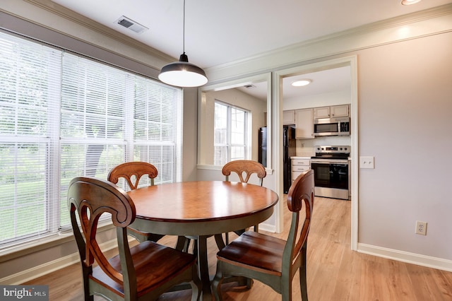 8060 Stonewall Brigade Ct Unit 101, Manassas, VA 20109 - dining area with baseboards, ornamental molding, and light wood-type flooring