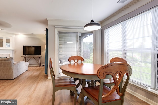 8060 Stonewall Brigade Ct Unit 101, Manassas, VA 20109 - dining space with baseboards, light wood finished floors, ornamental molding, and a fireplace