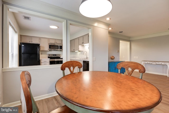 8060 Stonewall Brigade Ct Unit 101, Manassas, VA 20109 - dining space with light wood finished floors, ornamental molding, baseboards, and recessed lighting