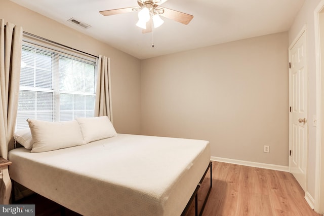 8060 Stonewall Brigade Ct Unit 101, Manassas, VA 20109 - bedroom featuring light wood-style flooring, baseboards, and ceiling fan