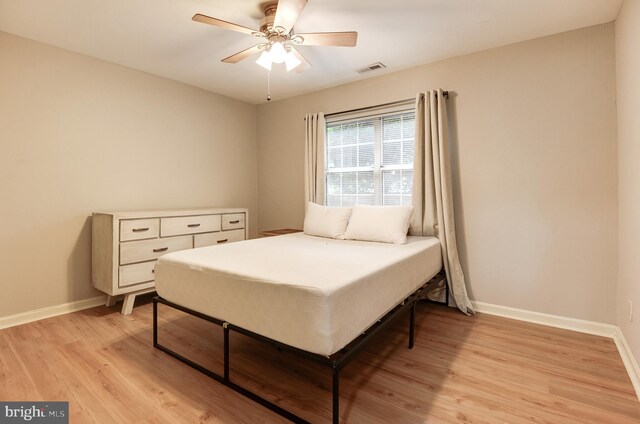 8060 Stonewall Brigade Ct Unit 101, Manassas, VA 20109 - bedroom featuring baseboards, light wood-style floors, and a ceiling fan