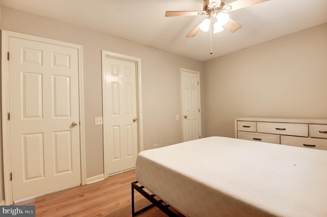 8060 Stonewall Brigade Ct Unit 101, Manassas, VA 20109 - bedroom with light wood-style flooring, baseboards, and a ceiling fan