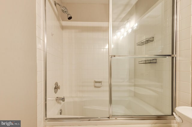 8060 Stonewall Brigade Ct Unit 101, Manassas, VA 20109 - bathroom featuring toilet and bath / shower combo with glass door