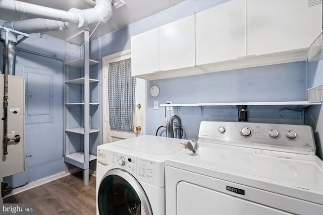 12804 Brunswick Ln, Bowie, MD 20715 - laundry area featuring independent washer and dryer, cabinet space, dark wood finished floors, and electric panel