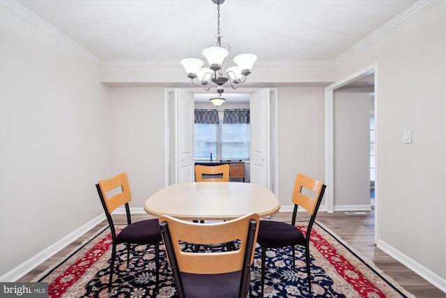 12804 Brunswick Ln, Bowie, MD 20715 - dining room featuring a chandelier, crown molding, light wood-type flooring, and baseboards