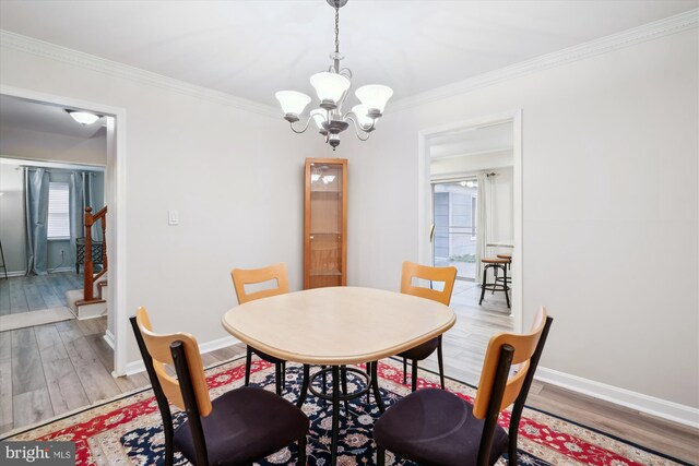 12804 Brunswick Ln, Bowie, MD 20715 - dining room with a chandelier, light wood finished floors, ornamental molding, baseboards, and stairway