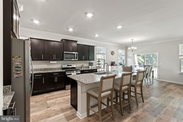 251 Rock Raymond Dr, Stafford, VA 22554 - kitchen featuring stainless steel appliances, a sink, a chandelier, ornamental molding, and light wood-type flooring