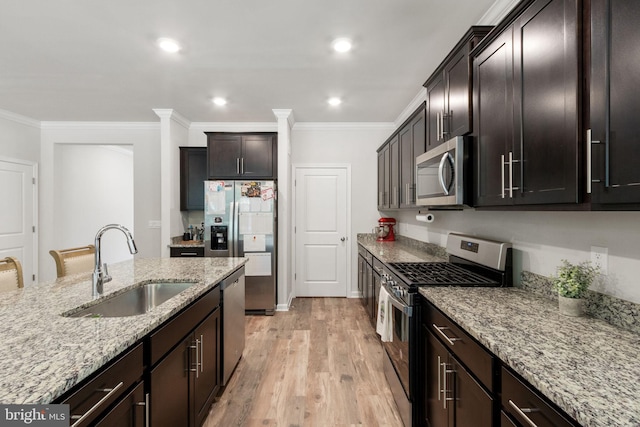 251 Rock Raymond Dr, Stafford, VA 22554 - kitchen featuring stainless steel appliances, a sink, crown molding, light stone counters, and light wood-style floors