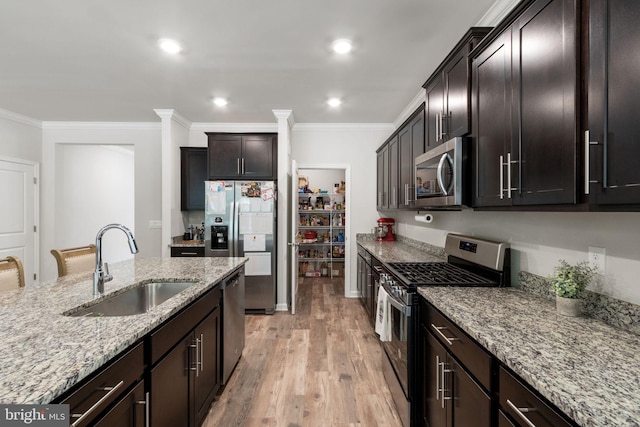 251 Rock Raymond Dr, Stafford, VA 22554 - kitchen with stainless steel appliances, a sink, crown molding, light stone countertops, and light wood-style flooring