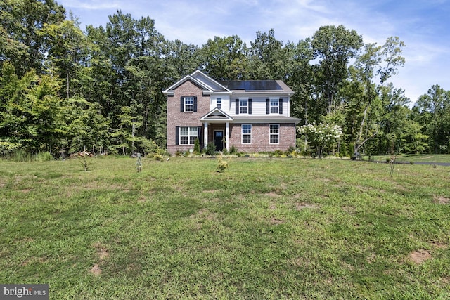 251 Rock Raymond Dr, Stafford, VA 22554 - traditional-style house featuring brick siding, solar panels, and a front yard