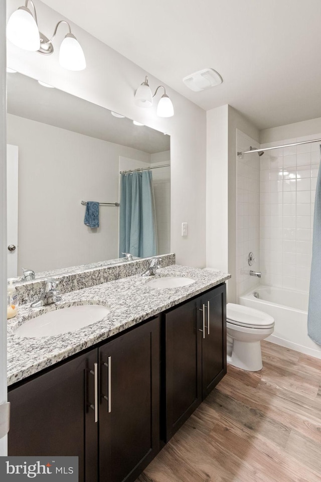 251 Rock Raymond Dr, Stafford, VA 22554 - bathroom with double vanity, wood finished floors, shower / bath combo, and toilet