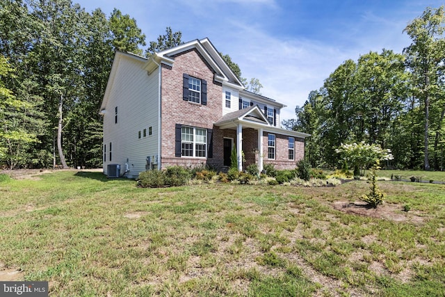 251 Rock Raymond Dr, Stafford, VA 22554 - view of front of home featuring brick siding, central AC, and a front lawn