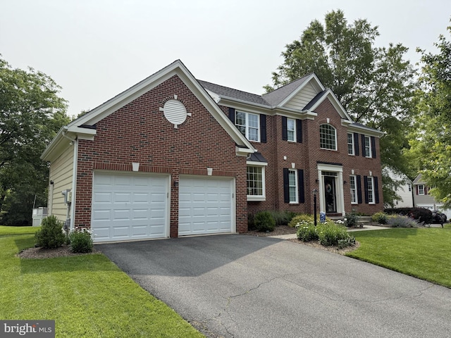 21526 Golden Autumn Pl, Broadlands, VA 20148 - view of front facade featuring driveway, brick siding, a front lawn, and an attached garage