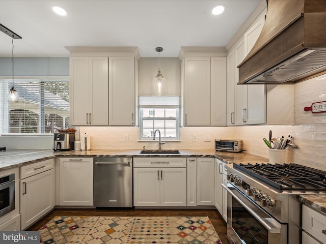 21526 Golden Autumn Pl, Broadlands, VA 20148 - kitchen with custom exhaust hood, stainless steel appliances, decorative backsplash, recessed lighting, and pendant lighting