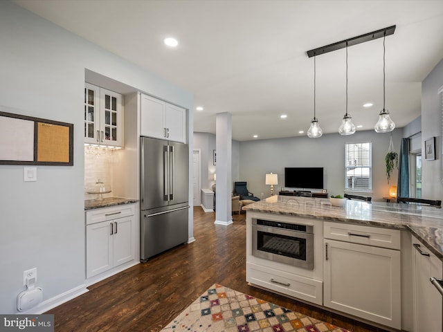 21526 Golden Autumn Pl, Broadlands, VA 20148 - kitchen with high end refrigerator, dark wood finished floors, tasteful backsplash, light stone counters, and recessed lighting