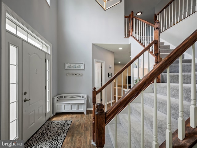 21526 Golden Autumn Pl, Broadlands, VA 20148 - entryway with a high ceiling, wood finished floors, stairs, recessed lighting, and a chandelier