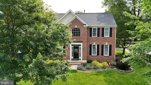 21526 Golden Autumn Pl, Broadlands, VA 20148 - view of front of home with brick siding, a front lawn, and a shingled roof