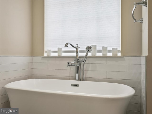 21526 Golden Autumn Pl, Broadlands, VA 20148 - bathroom with tile walls and a freestanding bath
