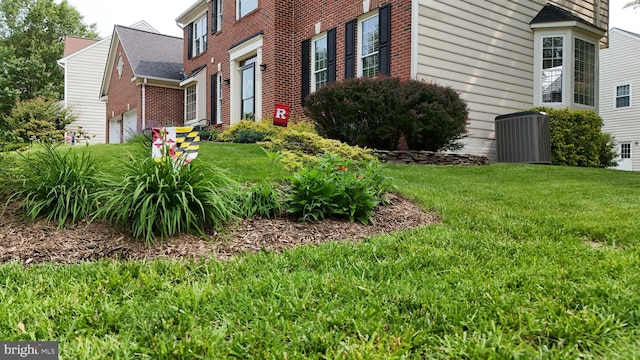 21526 Golden Autumn Pl, Broadlands, VA 20148 - view of home's exterior with brick siding, a lawn, and a garage