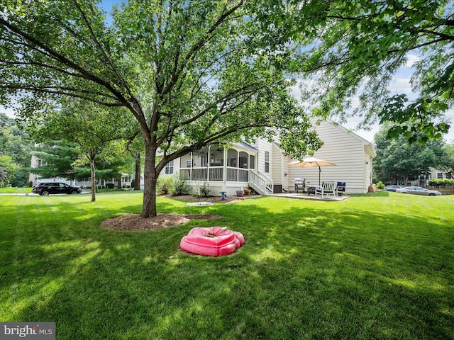 21526 Golden Autumn Pl, Broadlands, VA 20148 - view of grassy yard with a sunroom and a patio area
