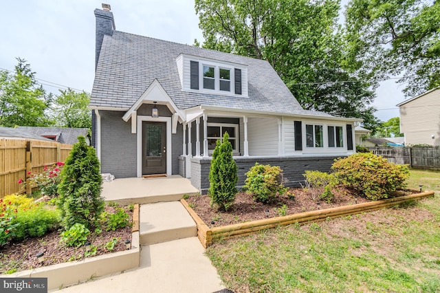 309 Bayview Rd, Edgewater, MD 21037 - view of front facade with a chimney, a high end roof, and brick siding