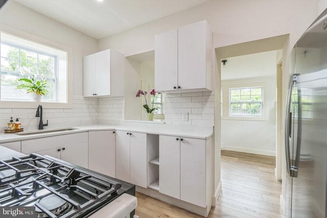 309 Bayview Rd, Edgewater, MD 21037 - kitchen featuring freestanding refrigerator, a sink, light countertops, white cabinetry, and tasteful backsplash