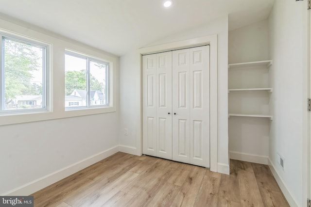 309 Bayview Rd, Edgewater, MD 21037 - unfurnished bedroom featuring lofted ceiling, light wood finished floors, a closet, and baseboards