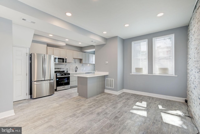 2915 Baker St, Baltimore, MD 21216 - kitchen featuring stainless steel appliances, a sink, light countertops, decorative backsplash, and recessed lighting