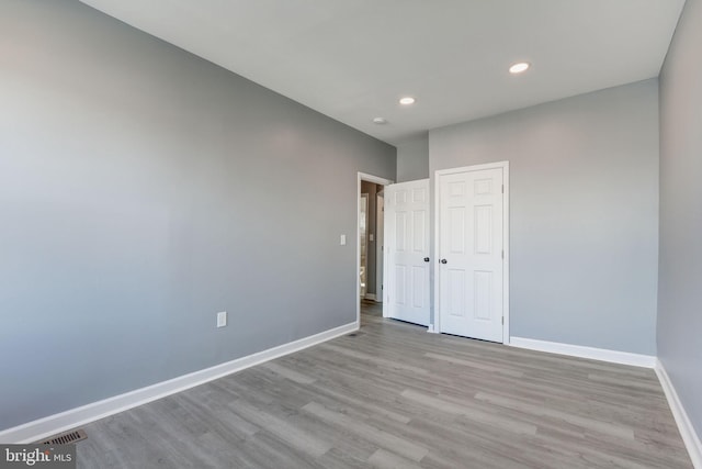 2915 Baker St, Baltimore, MD 21216 - unfurnished bedroom featuring wood finished floors, baseboards, recessed lighting, and a closet