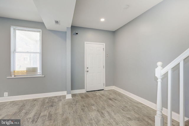 2915 Baker St, Baltimore, MD 21216 - foyer entrance with wood finished floors, baseboards, and stairway