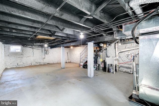 2915 Baker St, Baltimore, MD 21216 - basement with stairs, gas water heater, gas meter, a sink, and heating unit