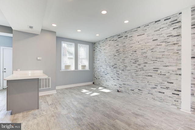2915 Baker St, Baltimore, MD 21216 - unfurnished living room with baseboards, recessed lighting, light wood-type flooring, and an accent wall