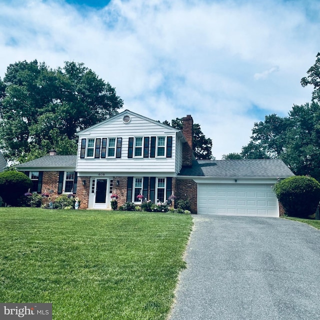 608 Windmill Ln, Silver Spring, MD 20905 - view of front of home with driveway, a chimney, brick siding, and a garage