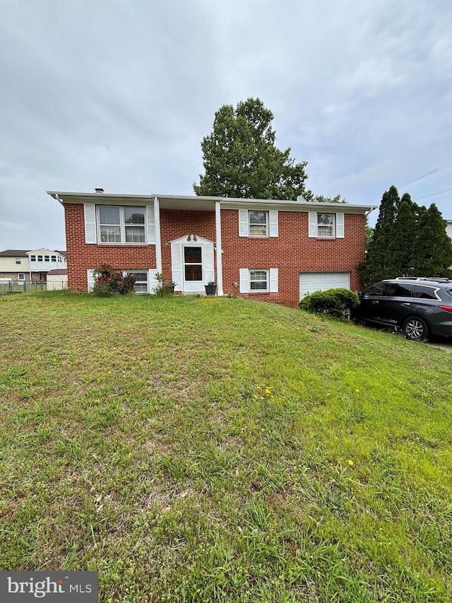 8916 Goldfield Pl, Clinton, MD 20735 - raised ranch featuring brick siding, a front lawn, and an attached garage