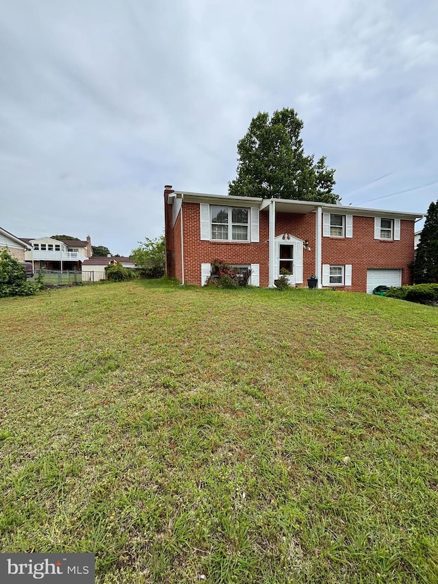 8916 Goldfield Pl, Clinton, MD 20735 - split foyer home with brick siding, an attached garage, and a front yard