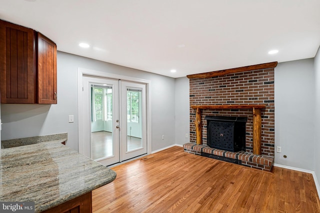 3414 Tyburn Tree Ct, Herndon, VA 20171 - unfurnished living room featuring light wood finished floors, french doors, baseboards, recessed lighting, and a brick fireplace