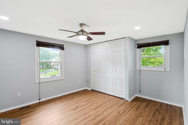 3414 Tyburn Tree Ct, Herndon, VA 20171 - unfurnished bedroom featuring multiple windows, baseboards, wood finished floors, a closet, and recessed lighting