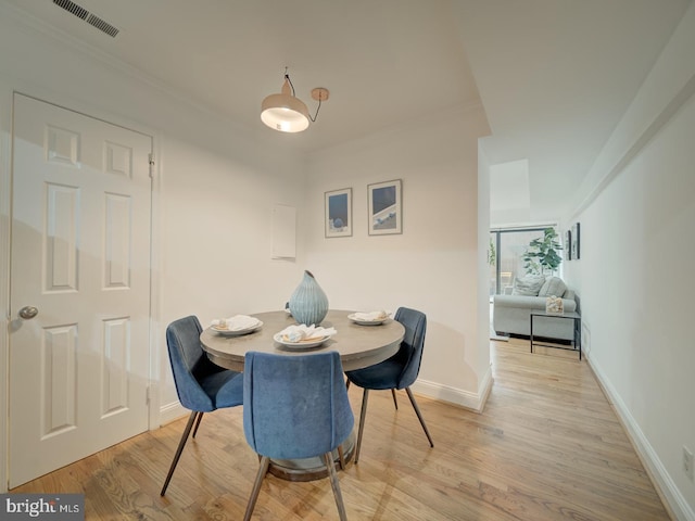 1715 15th St NW Unit 23, Washington, DC 20009 - dining space featuring light wood-style floors, baseboards, and ornamental molding