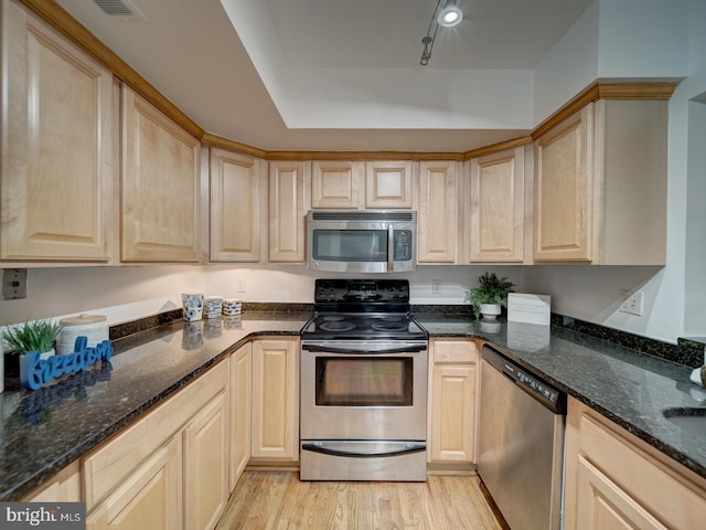 1715 15th St NW Unit 23, Washington, DC 20009 - kitchen with stainless steel appliances, light brown cabinetry, light wood finished floors, and dark stone countertops