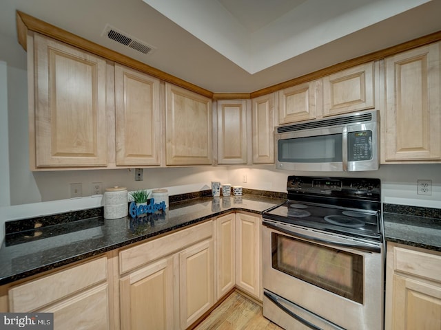 1715 15th St NW Unit 23, Washington, DC 20009 - kitchen featuring appliances with stainless steel finishes, light brown cabinetry, dark stone countertops, and light wood-style floors