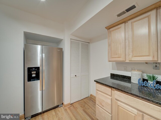 1715 15th St NW Unit 23, Washington, DC 20009 - kitchen with stainless steel refrigerator with ice dispenser, light brown cabinetry, light wood-type flooring, and dark stone countertops