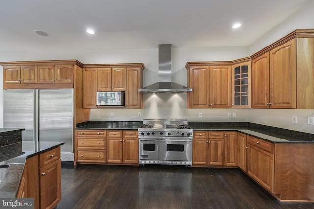 1496 Evans Farm Dr, Mclean, VA 22101 - kitchen featuring wall chimney range hood, high quality appliances, dark wood-type flooring, dark stone countertops, and brown cabinetry