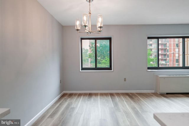 1200 S Arlington Ridge Rd Unit 205, Arlington, VA 22202 - empty room featuring wood finished floors, a chandelier, and healthy amount of natural light
